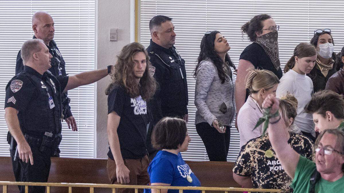 Demonstrators chant “Abortion rights now!” as General Assembly police usher them from the House gallery after the House gaveled into recess at the North Carolina State Legislature. Republican state lawmakers announced their plan to limit abortion rights across the state.