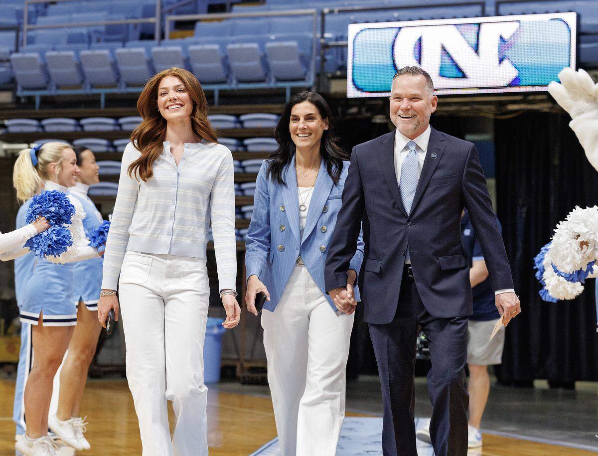 New North Carolina men’s basketball head coach Michael Malone arrives with his daughter, Bridget, and wife, Jocelyn, to an introductory press conference at the Smith Center on Tuesday, April 7, 2026, in Chapel Hill, N.C.