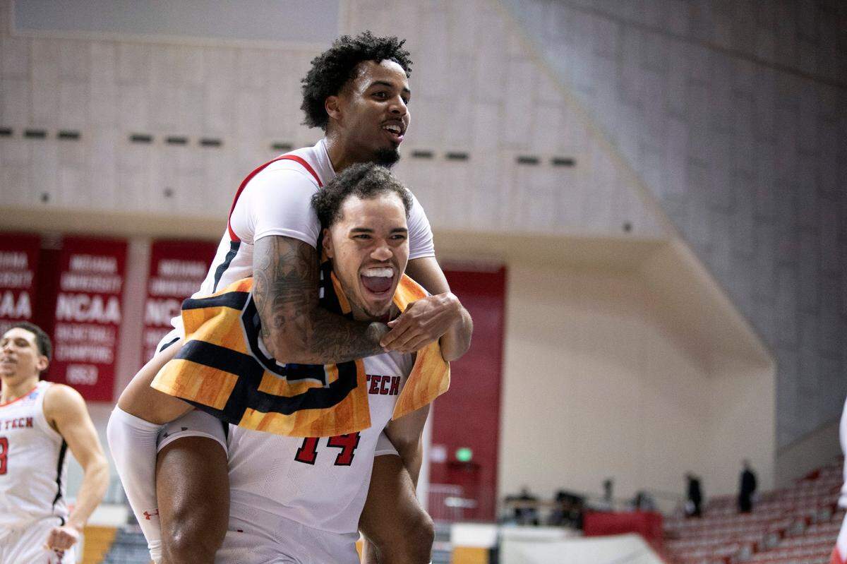 Texas Tech’s Kyler Edwards, top, and Marcus Santos-Silva (14) celebrate after a first-round game against Utah State in the NCAA men’s college basketball tournament, Friday, March 19, 2021, at Assembly Hall in Bloomington, Ind. 