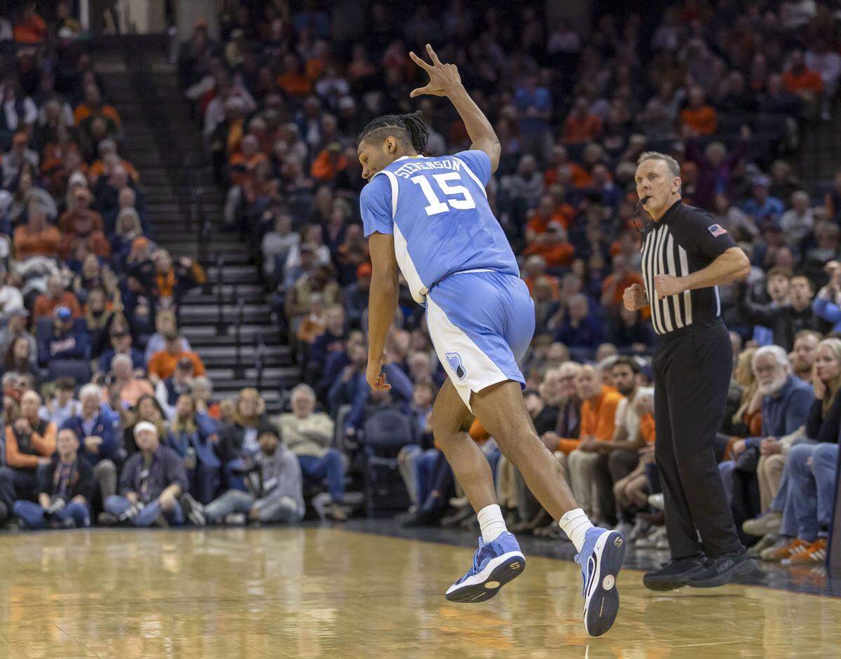 North Carolina forward Jarin Stevenson (15) flashes three fingers after sinking a clutch three-point basket to give the Tar Heels an 81-74 lead in the closing minutes against Virginia on Saturday, January 24, 2026 at John Paul Jones Arena in Charlottesville, Va.  Stevenson scored 17 points in the Tar Heels’ 85-80 victory. 