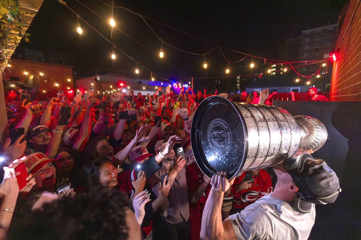 Carolina Hurricanes fans celebrate the team's Stanley Cup Final victory at Teets in Raleigh's Glenwood South district as the Stanley Cup, accompanied by Hurricanes players and staff, makes an appearance during a victory celebration Monday, June 15, 2026. The Hurricanes defeated the Vegas Golden Knights 4-2 in the Stanley Cup Final to win the franchise's second championship since 2006.