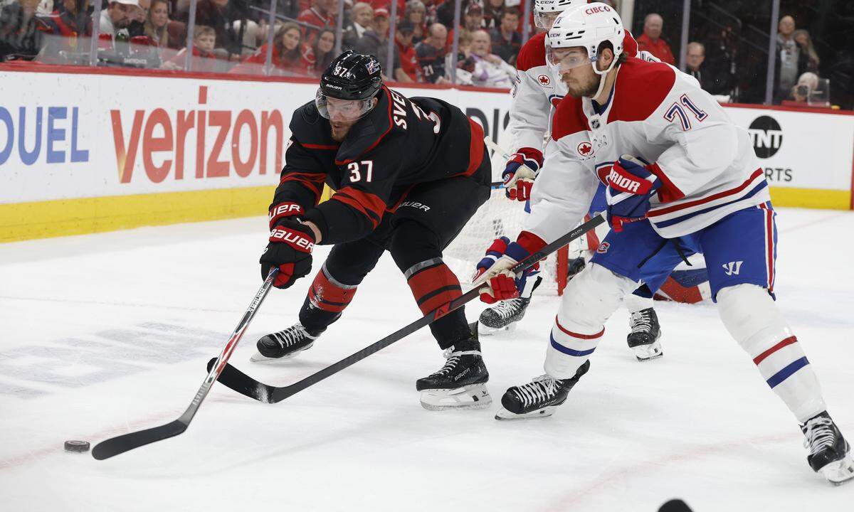 Carolina's Andrei Svechnikov (37) and Montréal's Jake Evans (71) go after the puck in the first period of the Hurricanes’ game against the Canadiens in game two of the Eastern Conference Finals at the Lenovo Center in Raleigh, N.C., Saturday, May 23, 2026.
