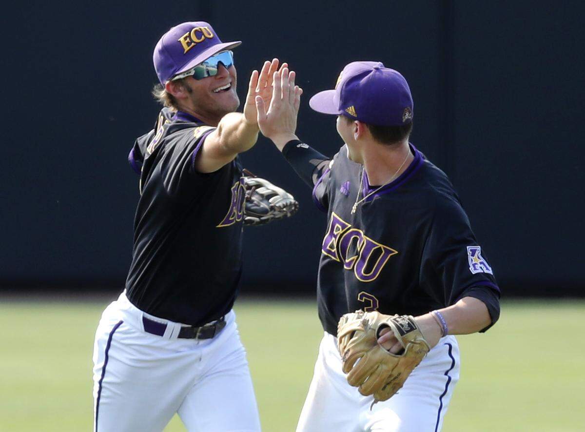 ECU’s Nick Barber (2), left, high-fives Ryder Giles (3) after East Carolina’s 10-3 victory over Campbell in the Greenville Regional at Clark-LeClair Stadium in Greenville, N.C., Monday, June 3, 2019.