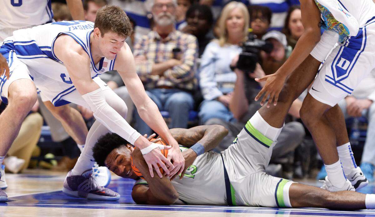 Duke’s Kyle Filipowski (30) tries to take the ball from Queens’ Deyton Albury (13) during the second half of Duke’s 106-69 victory over Queens University at Cameron Indoor Stadium in Durham, N.C., Saturday, Dec. 30, 2023.