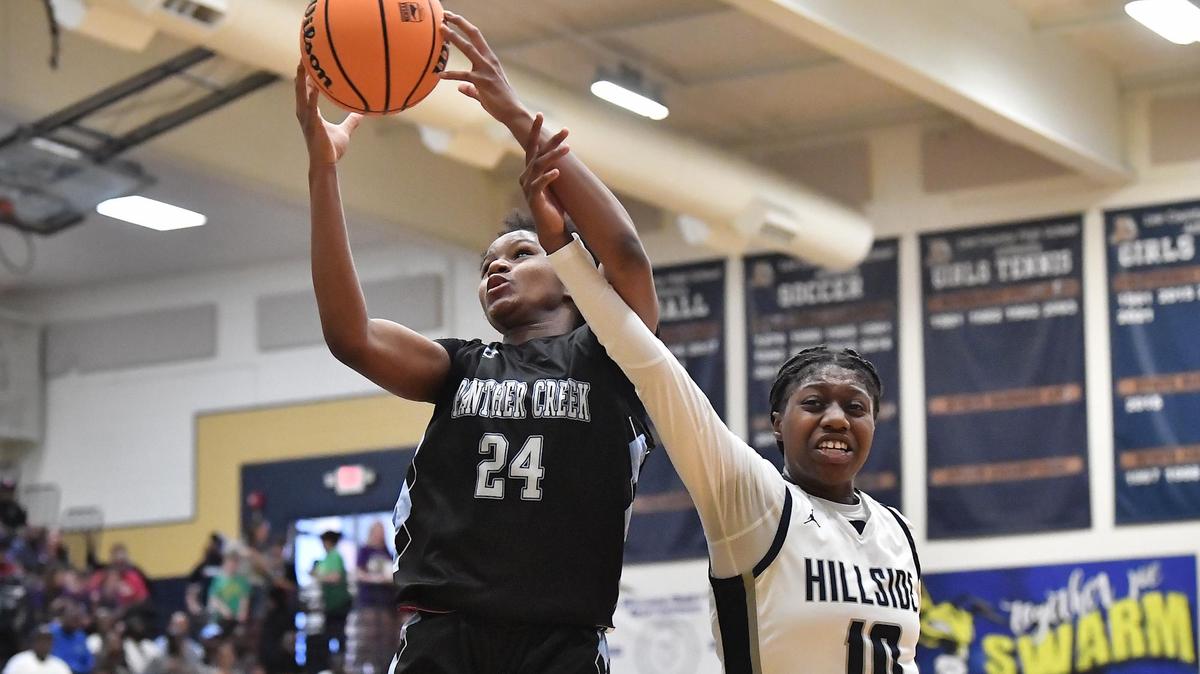 Panther Creek’s Kirstin Smalls (24) secures the rebound against Hillside’s Dorinda Jordan (10) during the first half. The Hillside Hornets and the Panther Creek Catamounts met in the NCHSAA 4A East Regional Finals in Sanford, N.C. on March 4, 2023.