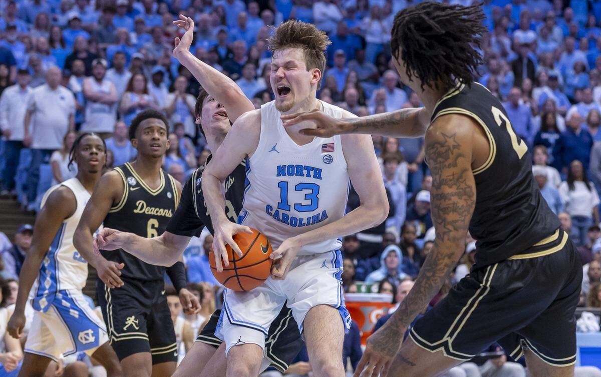 North Carolina center Henri Veesaar (13) works his way to the basket against Wake Forest forward Cooper Schwieger (13) and guard Juke Harris (2) in the second half on Saturday, January 10, 2026 at the Smith Center in Chapel Hill, N.C. 