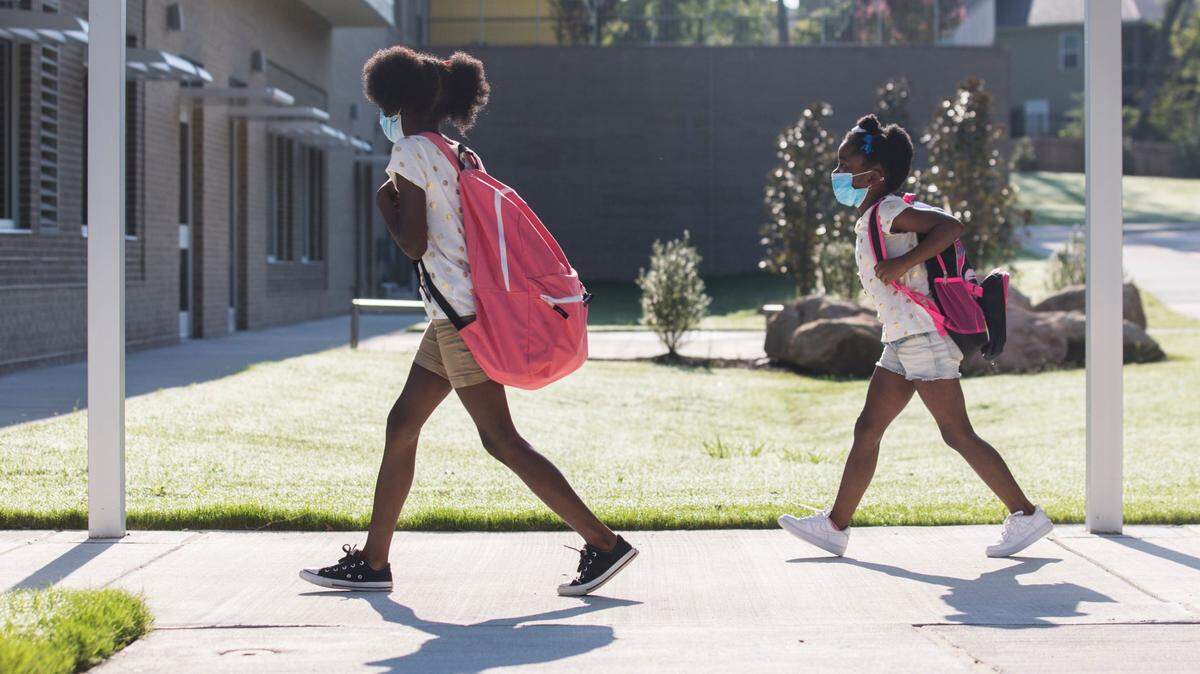 Students walk towards Conn Elementary School in Raleigh, N.C. on Monday, Aug. 23, 2021 for their first day of school.