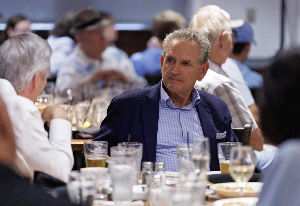 North Carolina Athletic Director Bubba Cunningham listens during a conversation during a break in the “Carolina Football Live” radio show at Top of the Hill Restaurant & Brewery on Wednesday, Aug. 27, 2025, in Chapel Hill, N.C.