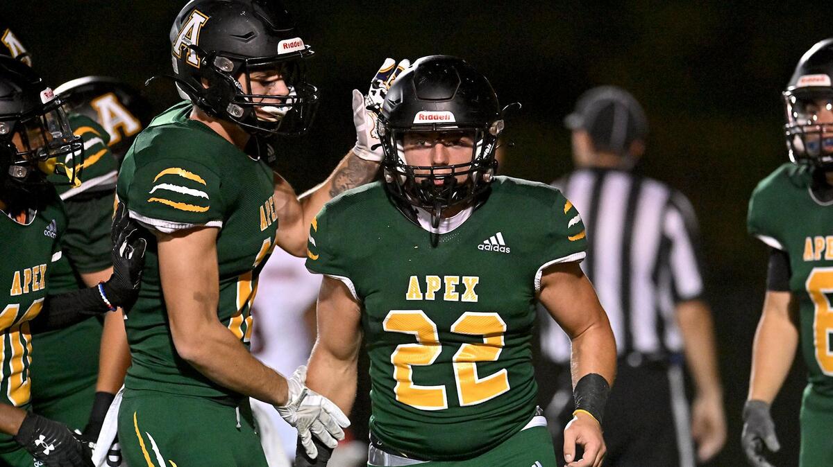 Apex’s Trey Barbee (12) congratulates running back Ian Bright (22) after his touchdown in the first half. The Apex Cougars and the and the Middle Creek Mustangs met in a football game in Apex, N.C. on October 14, 2022.