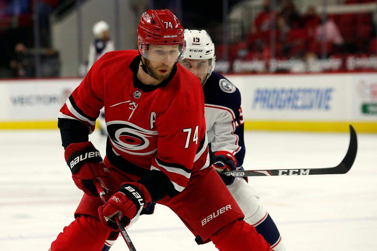 Carolina Hurricanes’ Jaccob Slavin (74) tries to control the puck against the Columbus Blue Jackets during the first period of an NHL hockey game in Raleigh, N.C., Saturday, May 1, 2021. (AP Photo/Karl B DeBlaker)