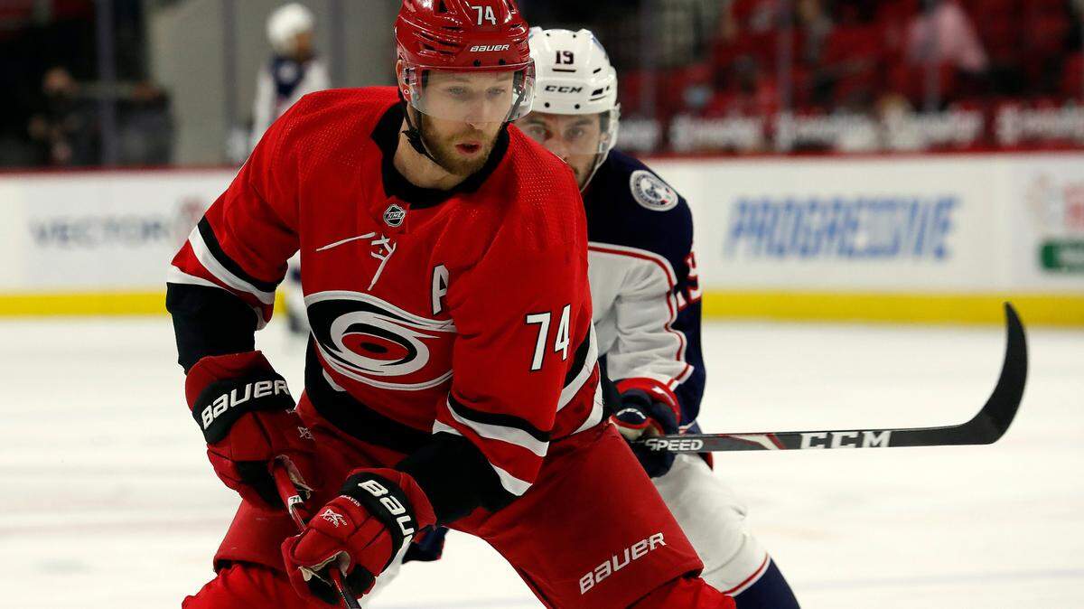 Carolina Hurricanes’ Jaccob Slavin (74) tries to control the puck against the Columbus Blue Jackets during the first period of an NHL hockey game in Raleigh, N.C., Saturday, May 1, 2021. (AP Photo/Karl B DeBlaker)