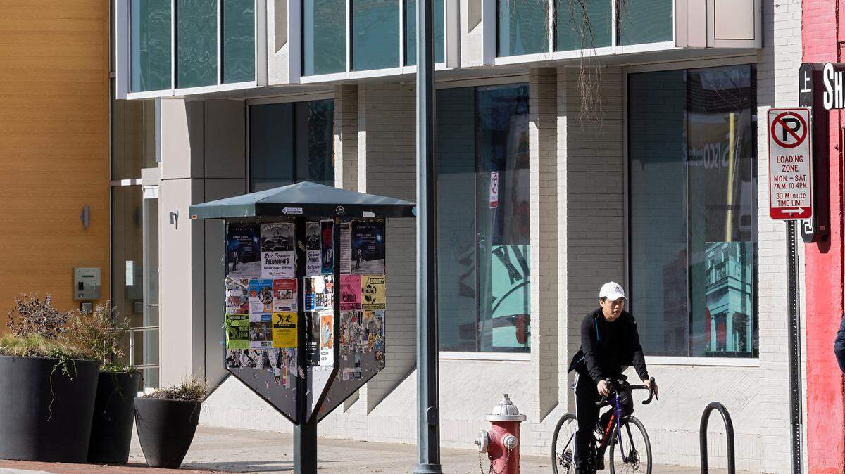 A cyclist rides by 137 East Franklin Street, a building that will become a part of Chapel Hill’s new downtown innovation district, on Friday, Jan. 20, 2023. 