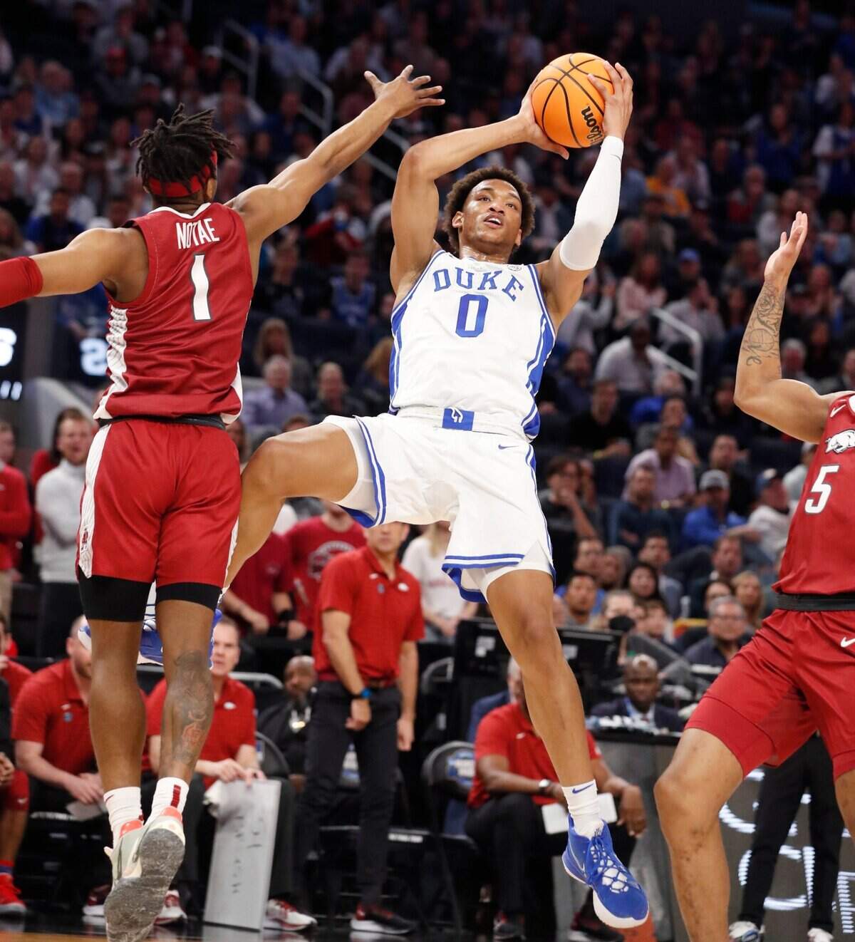 Dukes Wendell Moore Jr. (0) shoots as Arkansas’ JD Notae (1) defends during the first half of Dukes game against Arkansas in the NCAA Tournament West Regional finals at the Chase Center in San Francisco, Calif., Saturday, March 26, 2022.