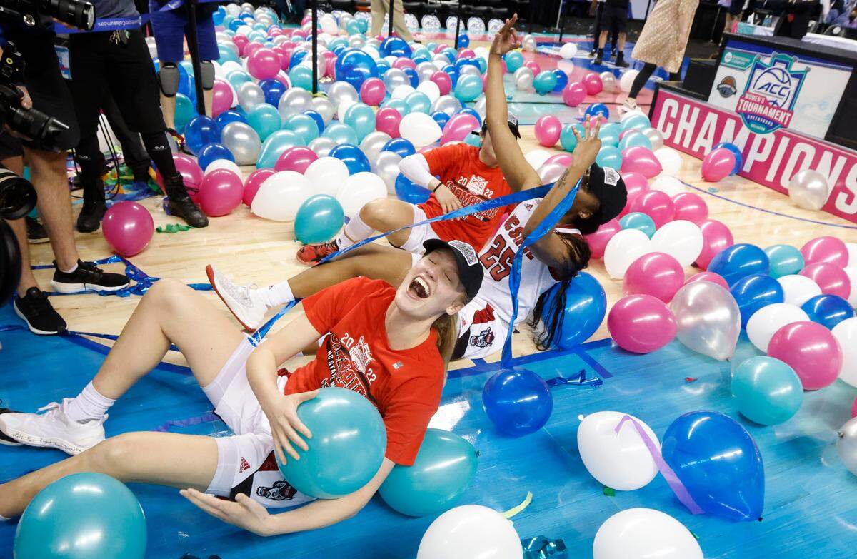 N.C. State’s Elissa Cunane (33), Kayla Jones (25) and Raina Perez (2) play in the balloons after the Wolfpack’s 60-47 victory over Miami to win the ACC women’s basketball tournament in Greensboro, N.C., Sunday, March 6, 2022.