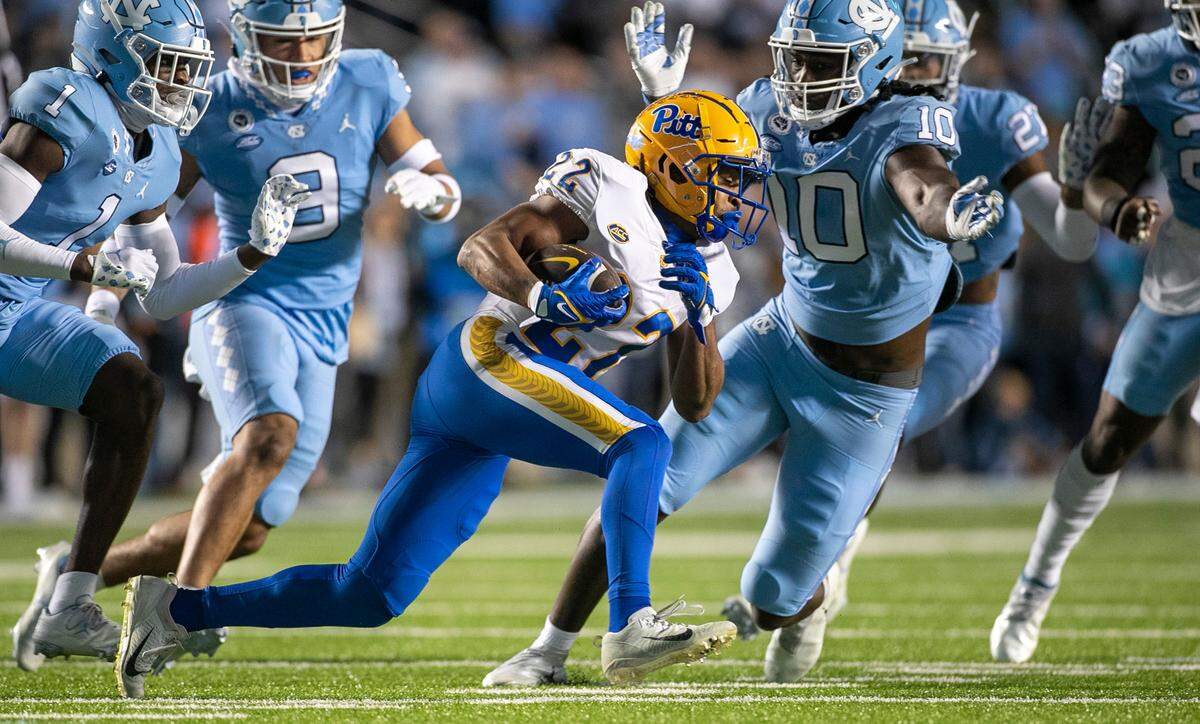 Pitt’s Vincent Davis (22) is stopped by North Carolina’s Desmond Evans (10) in the first quarter on Saturday, October 29, 2022 at Kenan Stadium in Chapel Hill, N.C.
