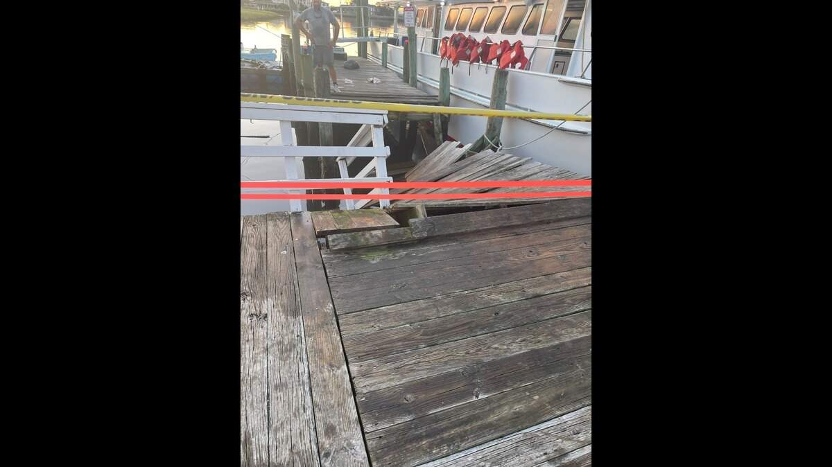A portion of a loading dock for Captain Stacy Fishing Center is roped off after it collapsed on Sept. 2, sending about 12 people into the water.