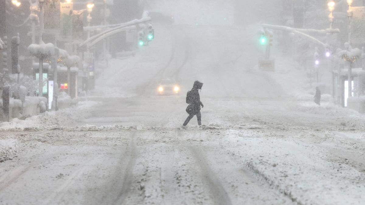 A person crosses 42nd Street in New York, February 23, 2026 during a snow strom. More than 40 million people were under blizzard warnings in the northeast  on Monday, as a winter storm dumped deep snow and officials in New York enforced a citywide travel ban. The so-called "Nor'easter" pummeled the region overnight, disrupting flights and leaving hundreds of thousands of homes and businesses without power. 