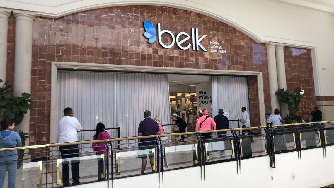 Shoppers wait to get into the Belk in Crabtree Valley Mall as it reopens Monday, May 11, 2020.
