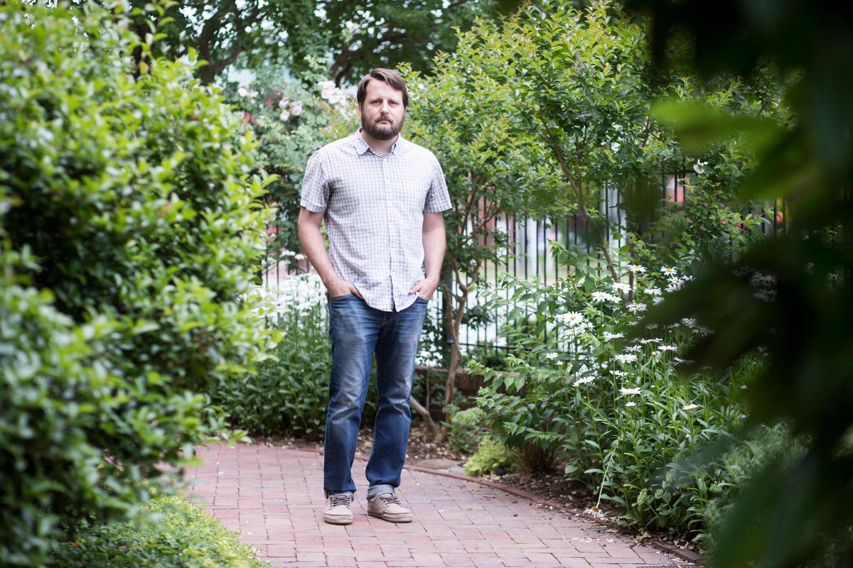 Bryan Lee poses for a portrait in the garden at Pullen Memorial Baptist Church on Thursday, May 23, 2019. Lee ministers to youth and their families and says he’s heard countless stories leading him to believe the academic and social cultures at Broughton High School are causing severe harm to the mental health of some students. He spoke about it at a Wake County school board meeting on Monday, May 20, 2019.