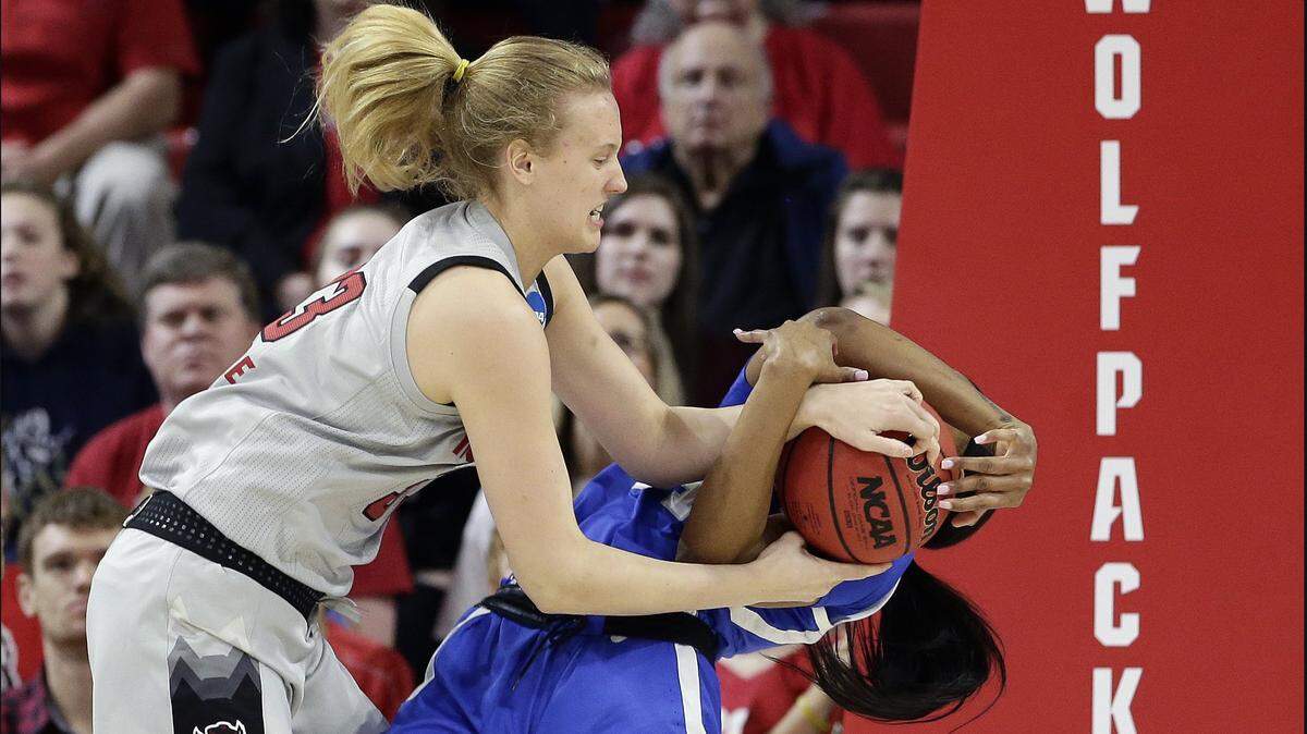 North Carolina State’s Elissa Cunane, left, grabs the ball with Kentucky’s Tatyana Wyatt during the first half of a second round women’s college basketball game in the NCAA Tournament in Raleigh, N.C., Monday, March 25, 2019. (AP Photo/Gerry Broome)