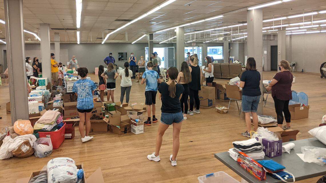 Volunteers listen to Carolina Peace Center Founder Faisal Khan speak at a donation center for Afghan refugees coming to the Triangle, on Saturday, Sept. 4, 2021.