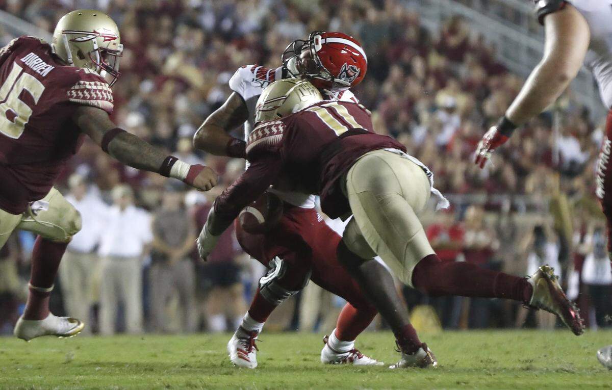 N.C. State quarterback Bailey Hockman (16) is sacked by Florida State defensive end Janarius Robinson (11) during the second half of Florida State’s 31-13 victory over N.C. State at Doak Campbell Stadium in Tallahassee, Fla., Saturday, Sept. 28, 2019 Robinson (11) was called for targeting on the play.