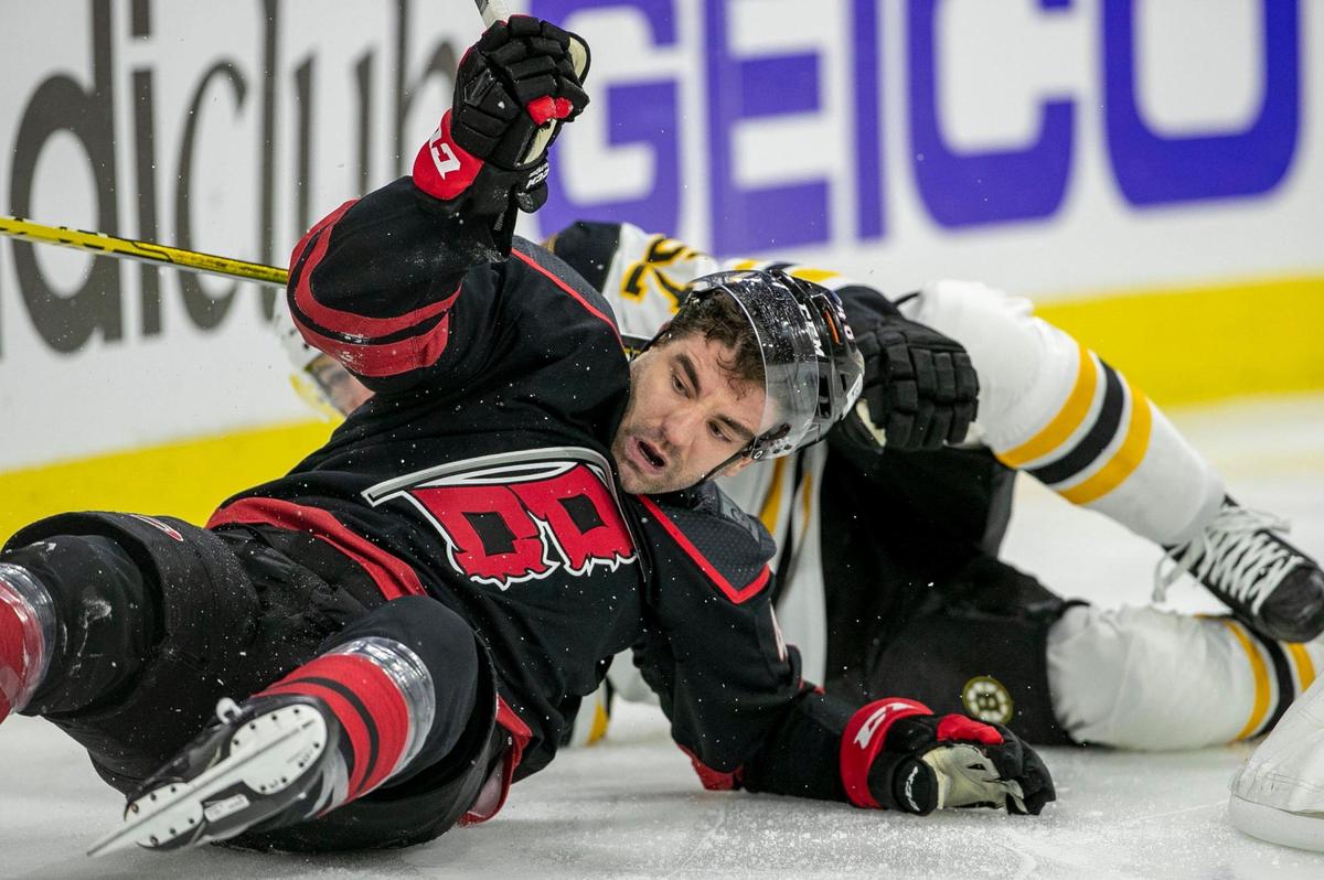 Carolina Hurricanes’ Jordan Martinook (48) and Boston’s Connor Clifton (75) battles for control of the puck in the first period on Monday, May 2, 2022 during game one of their Stanley Cup first round series at PNC Arena in Raleigh, N.C.