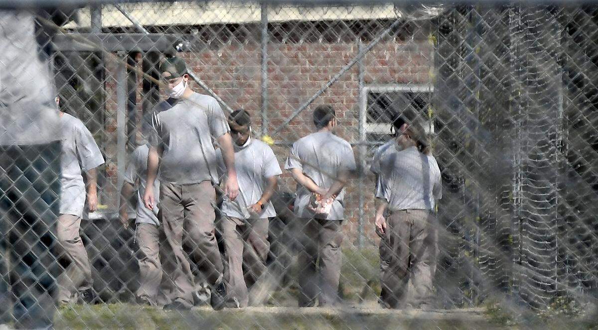 Inmates at the Neuse Correctional Institution in Goldsboro, N.C. move between buildings Sunday morning.