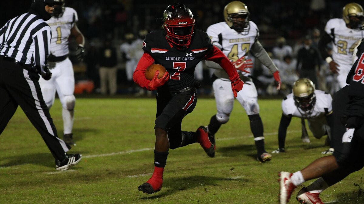 Middle Creek’s Jamoree Ellis (7) hits the hole during the Knightdale High School game against the Middle Creek High School in the  4A first round NCHSAA 4AA football playoffs., Nov 16, 2018, Apex , N.C.
