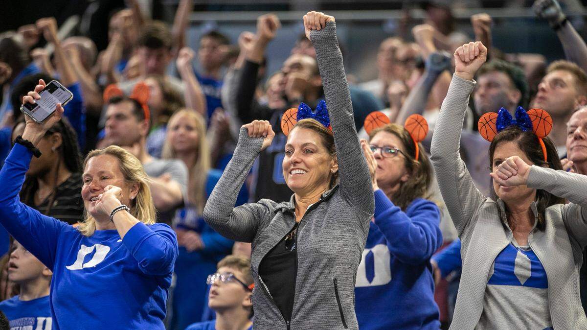 Debra Rosenbloum, center, celebrates with fellow Blue Devils fans during the closing minutes of play as Duke rolled to a 74-51 victory over Oral Roberts in the first round of the NCAA Tournament on Thursday, March 16, 2023 at the Amway Center in Orlando, Fla.