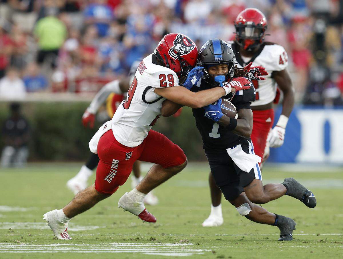 Duke’s Que'Sean Brown runs the ball under pressure from N.C. State’s Brody Barnhardt during the second half of the Blue Devils’ 45-33 win on Saturday, Sept. 20, 2025, at Wallace Wade Stadium in Durham, N.C.