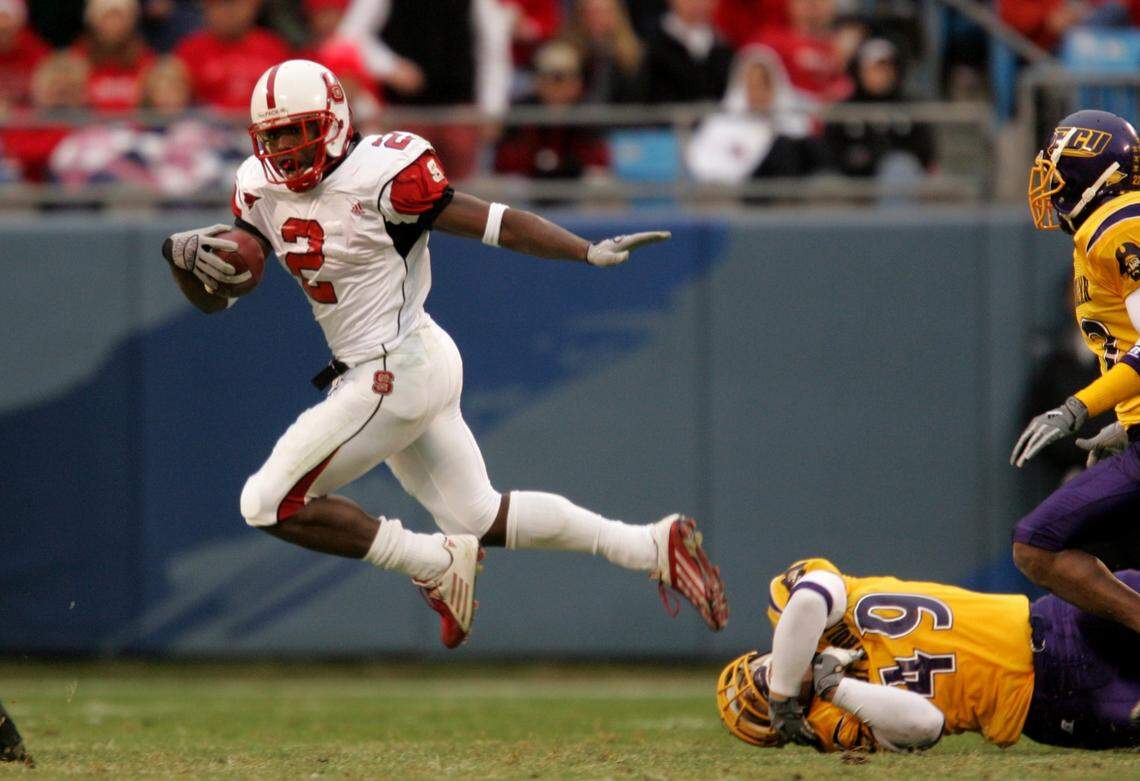 NC State’s Darrell Blackman (2) runs by ECU’s Wes Hofacker (49) during the Wolfpack’s 52-14 victory over the Pirates at Bank of America Stadium in Charlotte in 2004.
