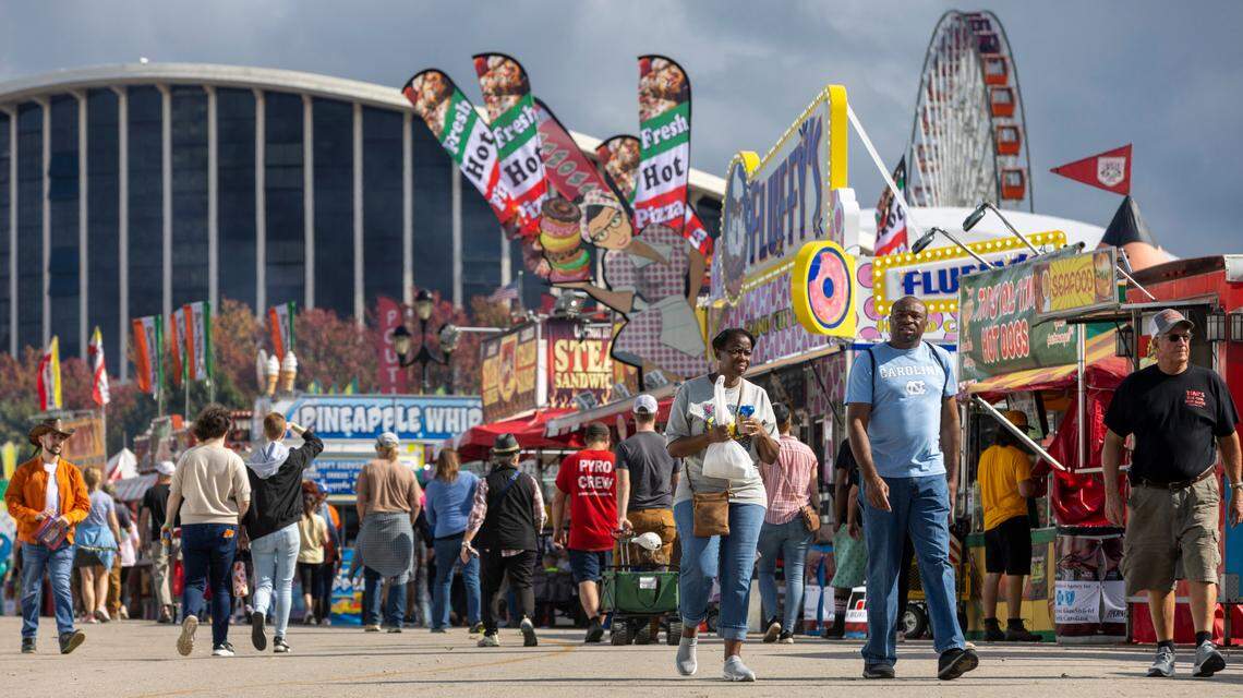 Fairgoers walk the midway on the opening day of the 2022 North Carolina State Fair on Thursday, October 13, 2022 in Raleigh, N.C.