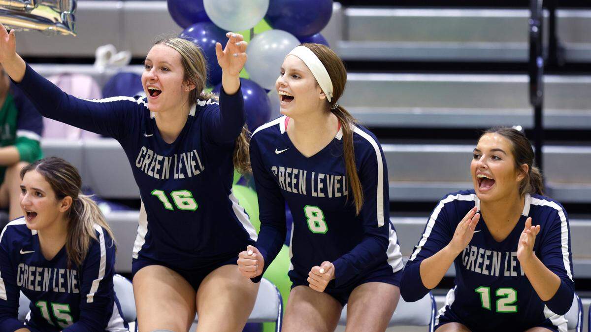 Green Level High School’s Reese Roper (8), center, along with teammates Lindley Miller (16), left, and Tristin Holt (12) cheer on the team during Green Level’s game against Middle Creek at Green Level High School in Cary, N.C., Tuesday, Oct. 10, 2023.