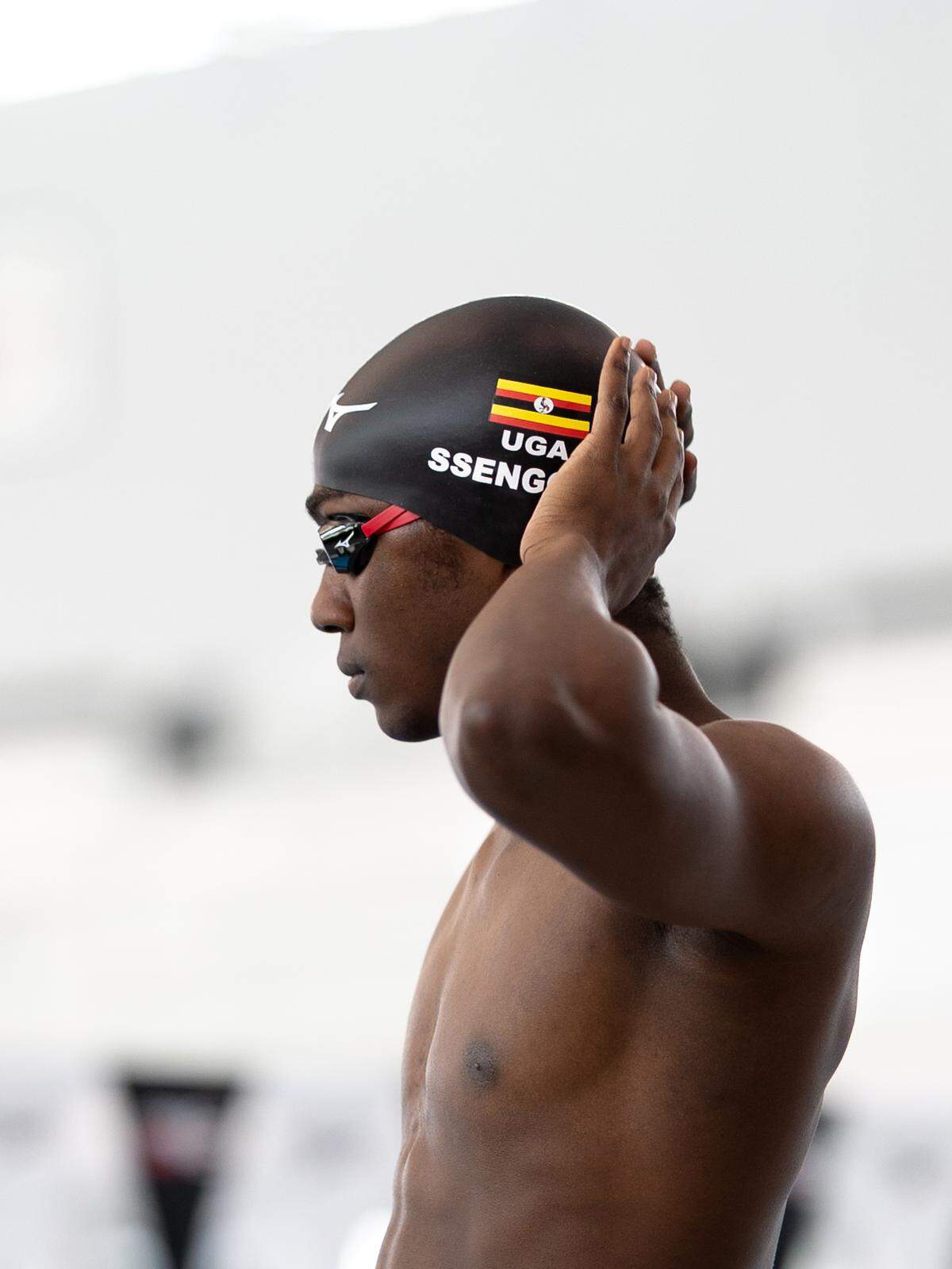 Jesse Ssengonzi dons his Ugandan National Team swim cap. The Green Hope High School graduate will swim for Uganda in the Paris Olympics.