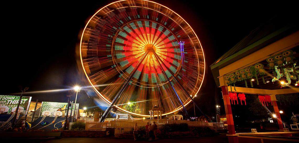 The Americana, a 110-foot tall Ferris wheel, is a flash of color against a night sky over Kings Dominion theme park in Virginia. The park is about a three-hour drive from the Triangle.
