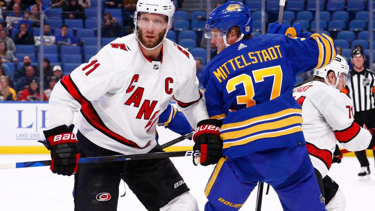 Carolina Hurricanes center Jordan Staal (11) and Buffalo Sabres center Casey Mittelstadt (37) word for position during the second period of an NHL hockey game Tuesday, April 5, 2022, in Buffalo, N.Y. (AP Photo/Jeffrey T. Barnes)