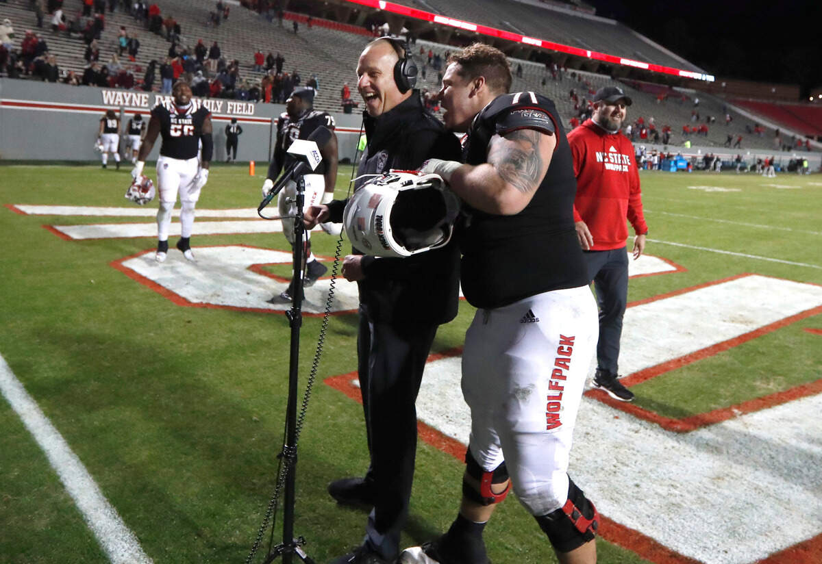 N.C. State guard Joe Sculthorpe (71) crashes head coach Dave Doeren’s interview after N.C. State’s 23-13 victory over Georgia Tech at Carter-Finley Stadium in Raleigh, N.C., Saturday, Dec. 5, 2020.