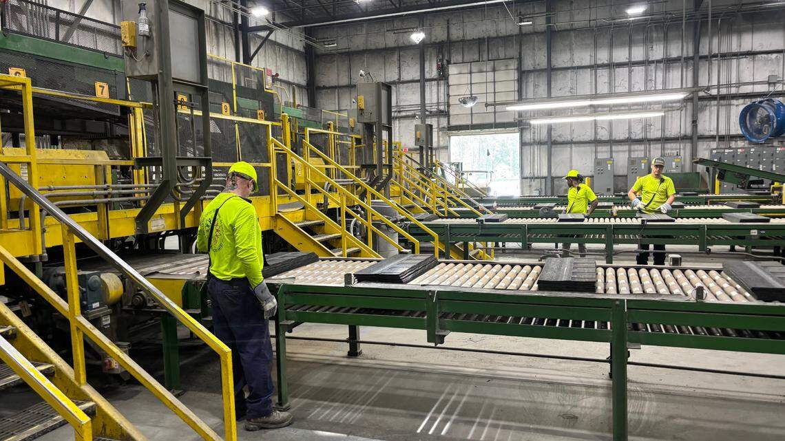 Workers produce roofing shingles at the CertainTeed plant in Oxford, NC on July 9, 2025.