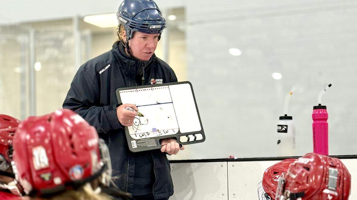 Hockey coach Jessica Hughes goes over drill instructions at a Junior Canes Girls U10 Red practice at Invisalign Arena at Wake Competition Center in Morrisville, N.C., on Thursday, Jan. 29, 2026.