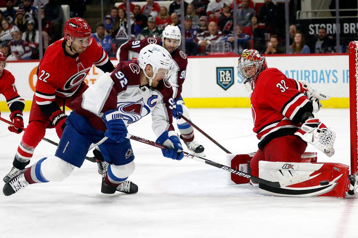 Carolina Hurricanes goaltender Antti Raanta (32) blocks the shot of Colorado Avalanche’s Gabriel Landeskog (92) with Hurricanes’ Brett Pesce (22) defending during the first period of an NHL hockey game in Raleigh, N.C., Thursday, March 10, 2022. (AP Photo/Karl B DeBlaker)