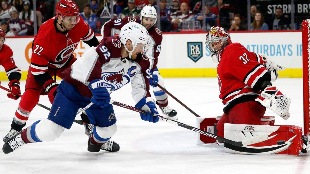Carolina Hurricanes goaltender Antti Raanta (32) blocks the shot of Colorado Avalanche’s Gabriel Landeskog (92) with Hurricanes’ Brett Pesce (22) defending during the first period of an NHL hockey game in Raleigh, N.C., Thursday, March 10, 2022. (AP Photo/Karl B DeBlaker)