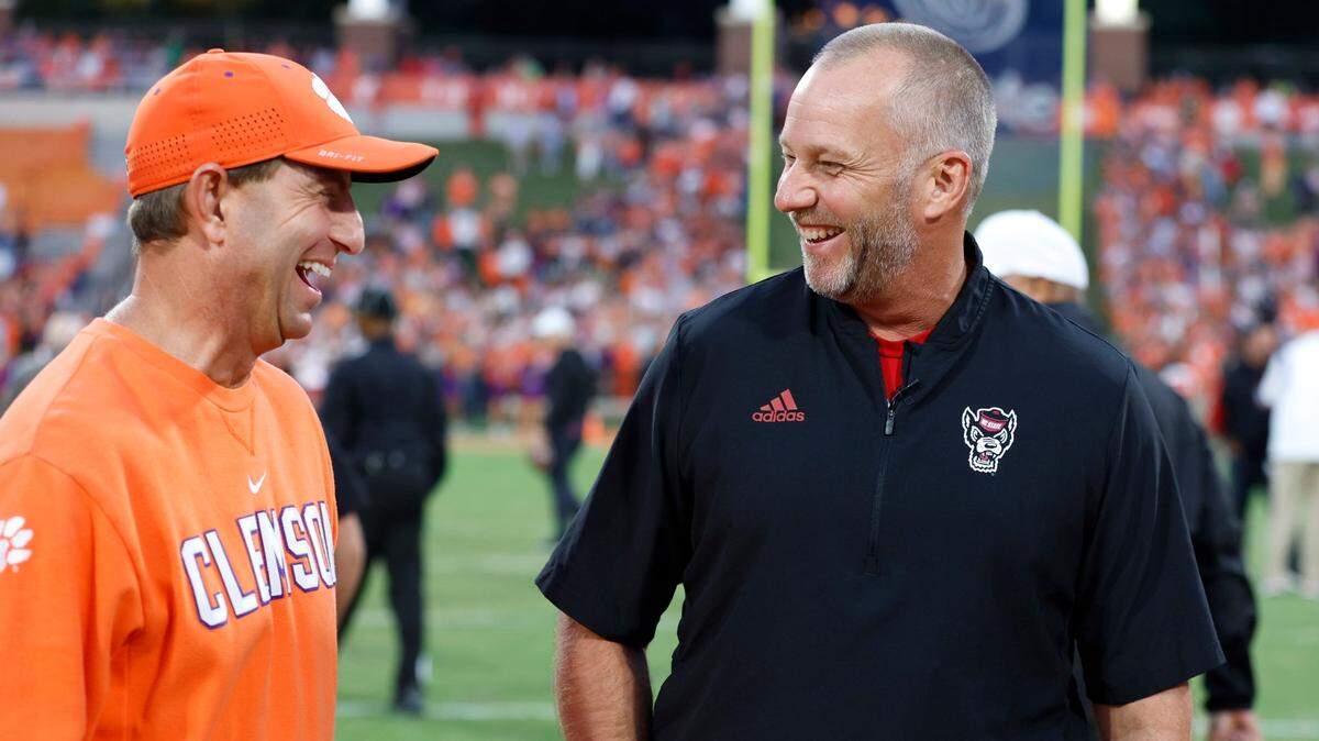 Clemson head coach Dabo Swinney laughs with N.C. State head coach Dave Doeren before N.C. State’s game against Clemson at Memorial Stadium in Clemson, S.C., Saturday, Oct. 1, 2022.