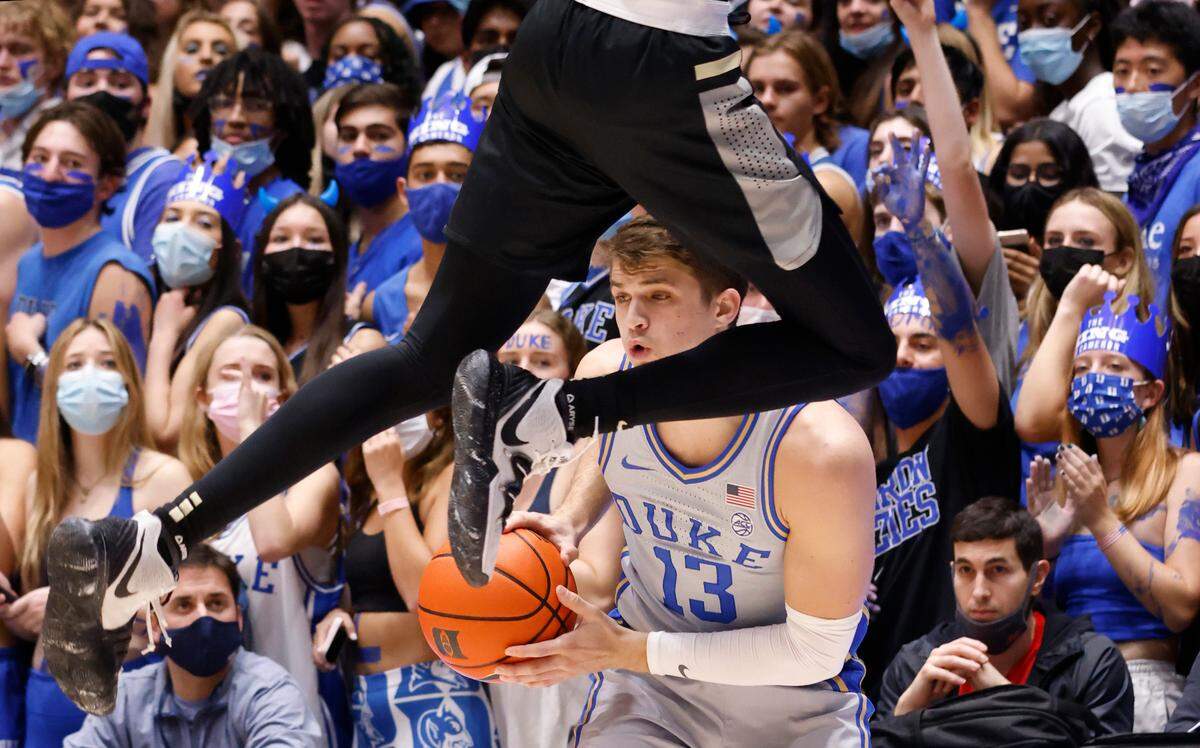 Duke’s Joey Baker (13) keeps the ball as Army’s Isaiah Caldwell (10) pressures him during the first half of Duke’s game against Army at Cameron Indoor Stadium in Durham, N.C., Friday, November 12, 2021.