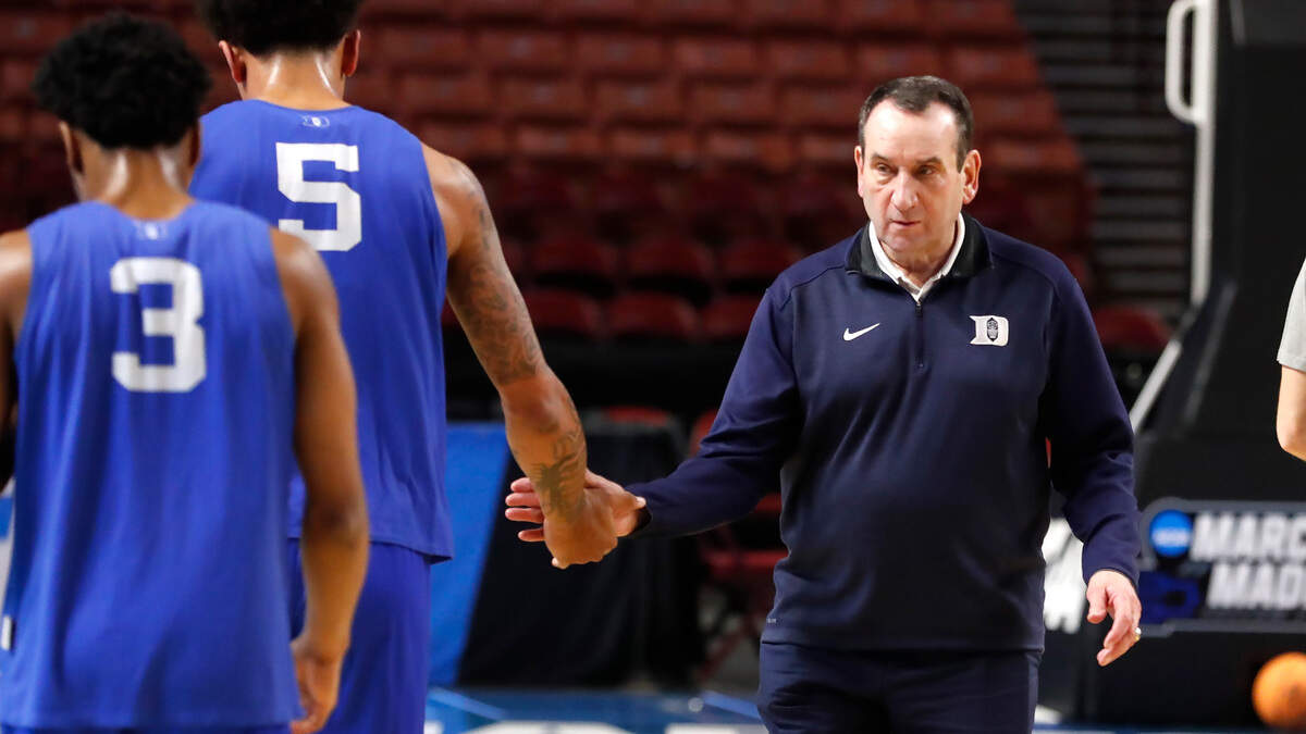 Duke head coach Mike Krzyzewski high-fives Paolo Banchero during the Blue Devils’ open practice at the Bon Secours Wellness Arena in Greenville, S.C., Thursday, March 17, 2022.