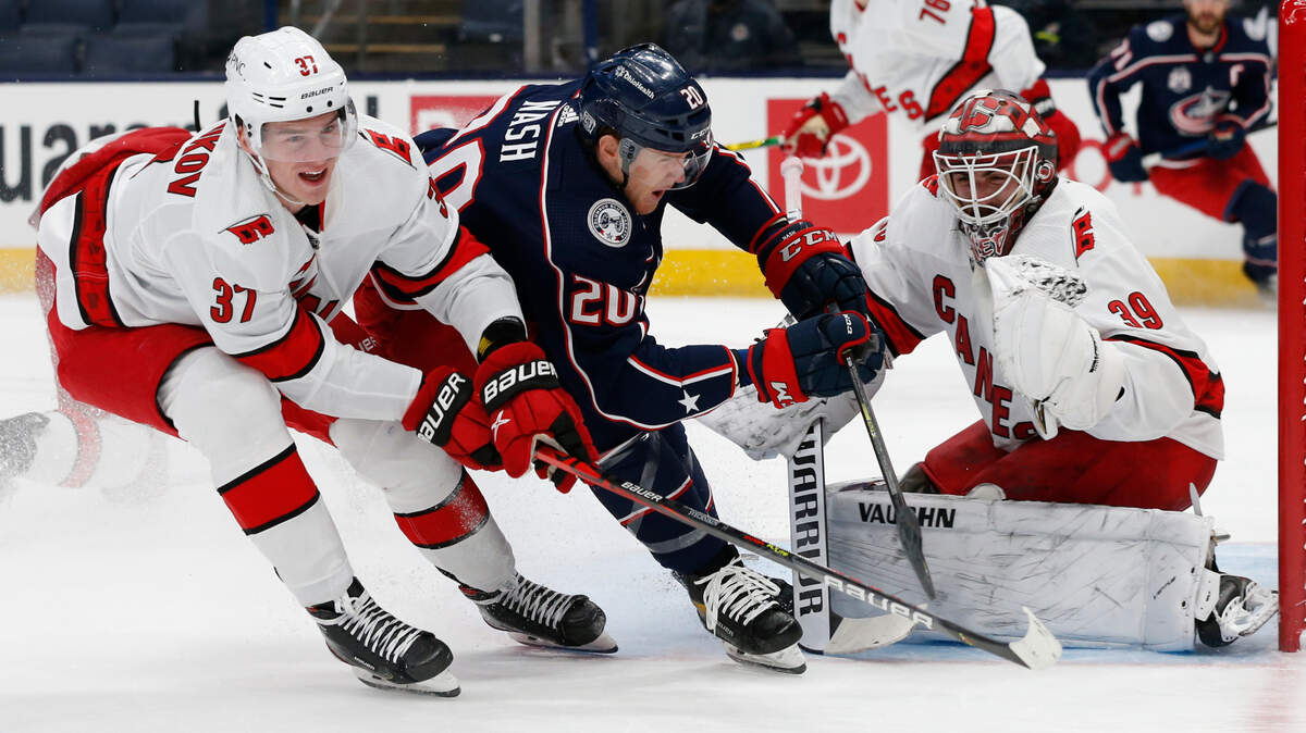 Carolina Hurricanes’ Alex Nedeljkovic, right, makes a save as teammate Andrei Svechnikov, left, defends against Columbus Blue Jackets’ Riley Nash during the second period of an NHL hockey game Monday, Feb. 8, 2021, in Columbus, Ohio.
