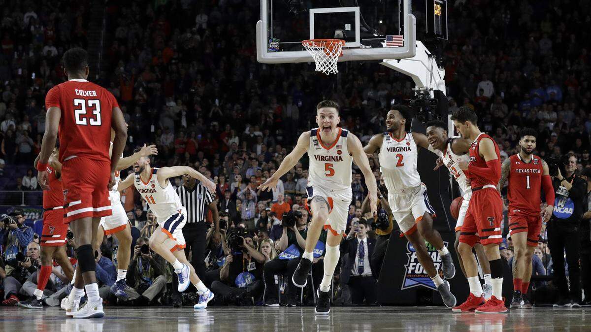 Virginia’s Kyle Guy (5) and his teammates celebrate after defeating Texas Tech 85-77 in the overtime in the championship of the NCAA tournament, Monday, April 8, 2019, in Minneapolis.