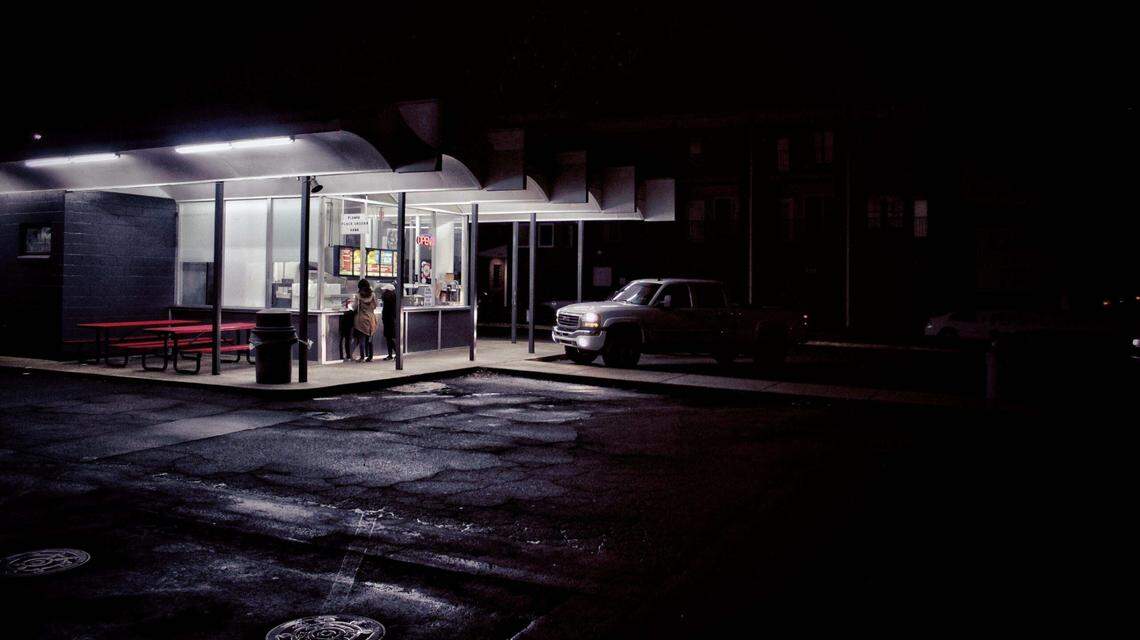 Stuart Dance would walk the streets at night while homeless, taking pictures of Raleigh, including this frame shot outside Char-Grill on Hillsborough Street.