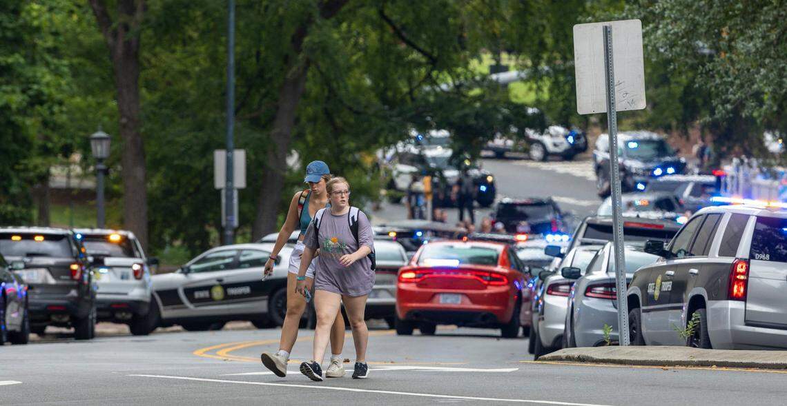 Students walk along South Road after a report of an armed and dangerous person on the University of North Carolina campus on Monday, August 28. 2023 in Chapel Hill, N.C.