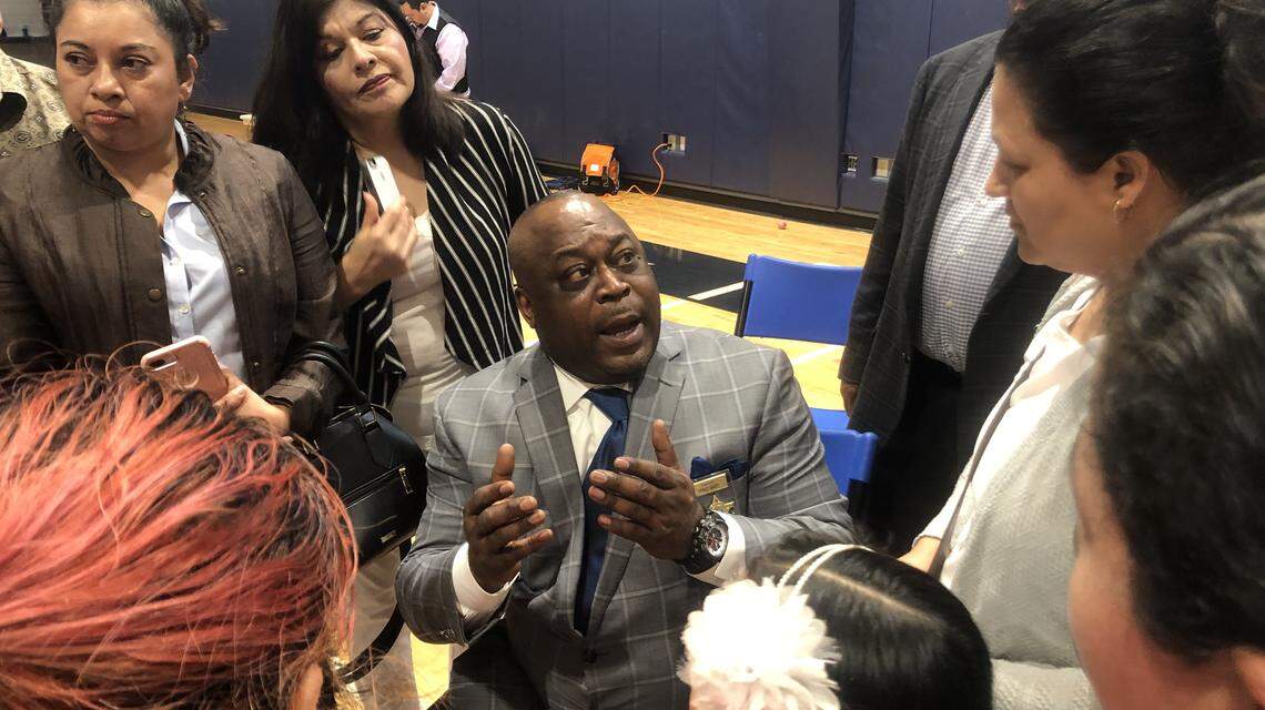 Wake County Sheriff Gerald Baker talks with Hispanic residents who attended a community meeting on March 10, 2019, at St. Michael the Archangel Church in Cary.